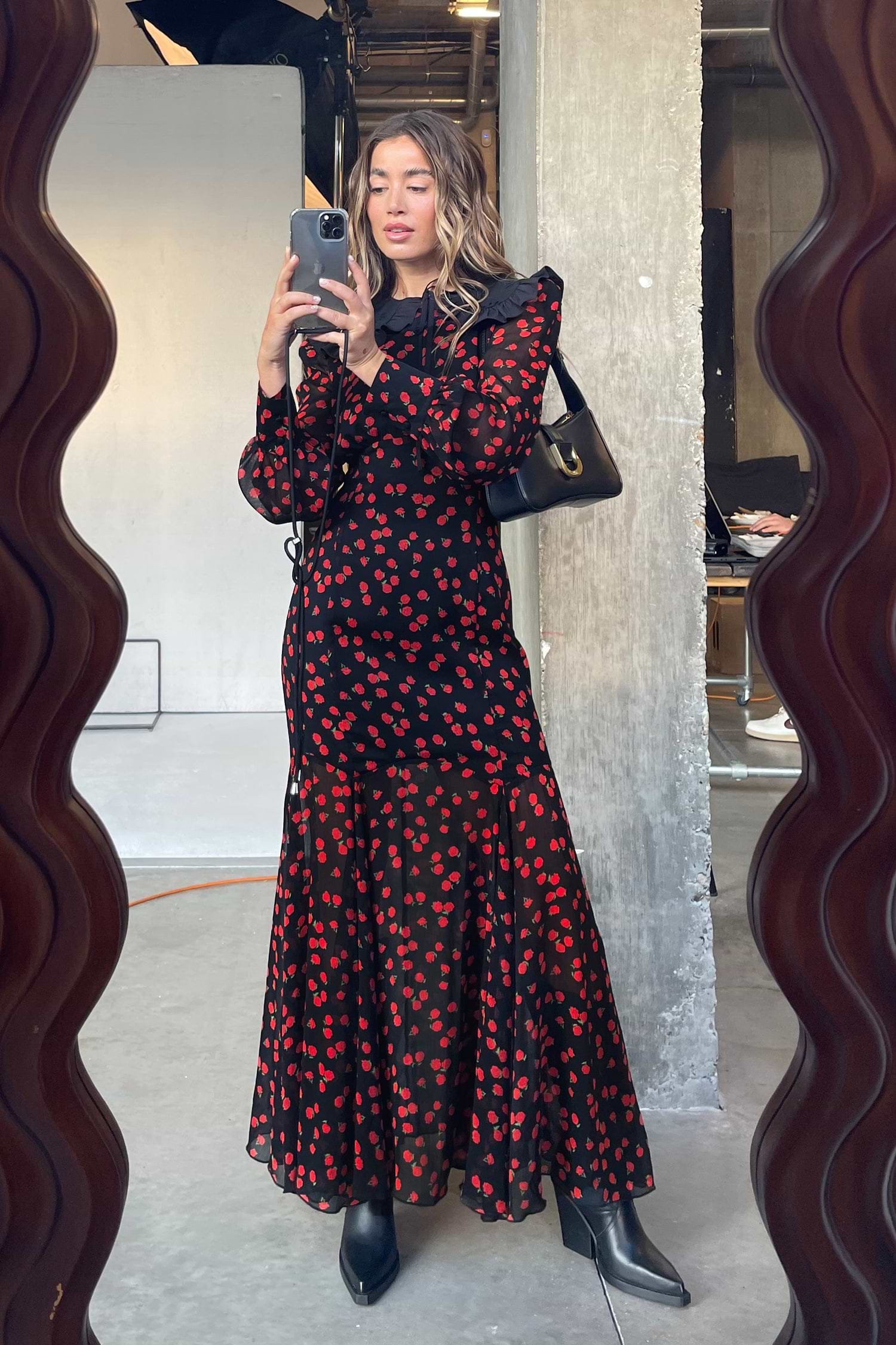 Model Wearing Black Rena Rose Midi Dress standing facing the camera