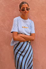 Blue cotton Cadillac Baby T-Shirt with a retro car motif, styled with a blue and navy striped skirt.