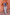 Thumbnail for Top canotta in maglia Blue Eye con cuori dorati, abbinato a jeans azzurro chiaro davanti a una parete rosa.