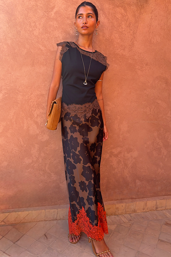 Model wearing a black and chocolate lace jersey top and Tan Jaden floral midi Maeva skirt.
