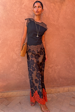 Black and Chocolate Lace Jersey Top with brown lace trim, styled with a floral skirt against a terracotta wall.