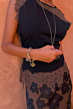 Close up of the Black and Chocolate Lace Jersey Top with chocolate lace trim and gold charm jewellery.