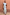 Thumbnail for Blue Stripe Alena Midi Dress with tiered multi-coloured stripes and ruffled sleeves against a terracotta wall.