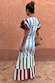 Blue Stripe Alena Midi Dress seen from the back with multi-coloured tiered stripes and burgundy frill sleeves.