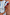 Thumbnail for Close up of the Blue Stripe Alena Midi Dress with burgundy ruffled sleeves and gold accessories.
