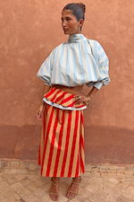 Blue Stripe Batwing Blouse with a high neck and batwing sleeves paired with a red striped maxi skirt.