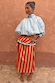 Blue Stripe Batwing Blouse with a high neck and batwing sleeves paired with a red striped maxi skirt.