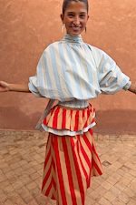 Model wearing the Blue Stripe Batwing Blouse with oversized sleeves and a high neck.