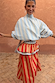Model wearing the Blue Stripe Batwing Blouse with oversized sleeves and a high neck.