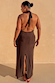 Model wearing the Chocolate Sabine Dress featuring an open back, halter neck tie, and split hem.