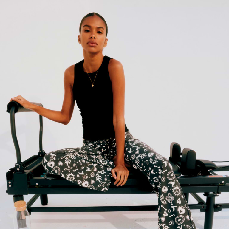 model is wearing the hope charcoal flare leggings with a black ribbed tank top 