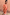 Thumbnail for Red and camel Tomato Stripe Blouse with voluminous sleeves and flared cuffs against a warm wall.