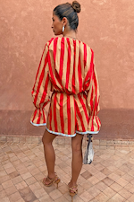 Model from behind wearing the red and camel Tomato Stripe Ellie Shorts and matching blouse co-ord.