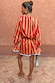 Model from behind wearing the red and camel Tomato Stripe Ellie Shorts and matching blouse co-ord.