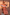 Thumbnail for Model wearing the red and camel Tomato Stripe Mini Dress with ruffle detailing and sunglasses.