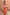 Thumbnail for Model wearing the Tomato Stripe Mini Dress with red and camel stripes and a ruffled off-the-shoulder neckline