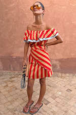 Tomato Stripe Scarf worn as a red and beige off-the-shoulder multi-wear dress on a model.