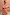 Thumbnail for Red, tan and light blue Tomato Stripe Scarf styled as a multi-wear ruffled top against a terracotta wall.