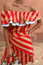 Red and tan Tomato Stripe Scarf styled as a waist wrap over a matching off-the-shoulder dress.