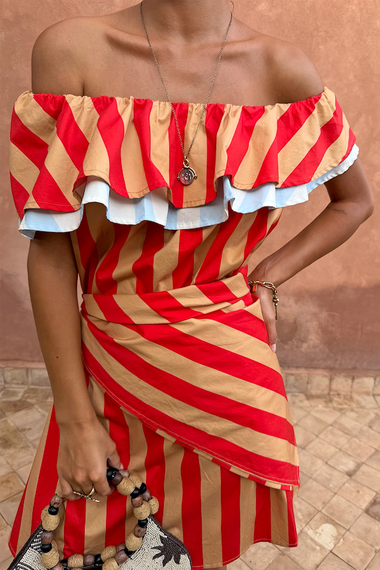 Red and tan Tomato Stripe Scarf styled as a waist wrap over a matching off-the-shoulder dress.