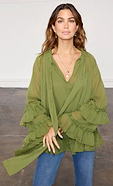 model is wearing the olive elinor blouse with the denim flare jeans 
