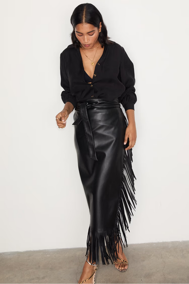 close up of our black vegan leather jaspre wrap skirt with fringe detailing 