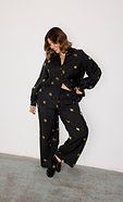 model is wearing the gold sun shirt and trousers co-ord