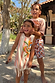 Girl wearing the cream Banana Jersey Cotton Dress with orange stripes and fringe hem on vacation.