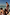 Thumbnail for Boy's Banana Print Swim Shorts in cream with multi-coloured patterns, worn by children on a sunny beach vacation.