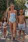 Blue Boy's Starburst Swim Shorts in Dreamer print, worn with family swimwear on vacation.