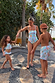Boy wearing Starburst Swim Shorts with a blue celestial print, playing outdoors with family in coordinated sets.