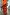 Thumbnail for Gonna rossa Celestial Dorris con stampe di soli e mani, abbinata a top arancione e borsa di perline.