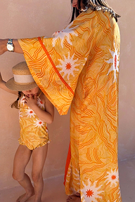 Girl's Yellow Sun Swimsuit with white sun print and frill trim, paired with a straw hat and matching kaftan.