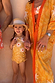Girl's Yellow Sun Swimsuit with frill details on a young girl wearing a straw hat on vacation.