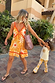 Girl's Yellow Sun Cotton Set featuring a sequin soleil sun vest and matching sun print flared trousers.