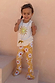 Girl wearing Yellow Sun Cotton Set with a sequined vest and flared trousers in a soleil sun motif.