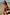 Thumbnail for Girls Pink Fruit Crop Bikini Set with Mediterranean fruit print and frill details on a sunny beach.