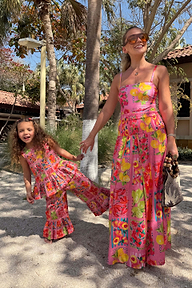 Pink fruit print wide leg set for girls, worn by a child standing on sand with an adult in a matching outfit.