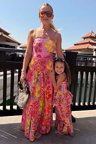 Girl wearing a pink fruit print wide leg set and peplum top, standing outdoors for a coordinated vacation look.