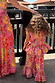Child wearing the Girl's Pink Fruit Wide Leg Set featuring a peplum top and frilled flared trousers.