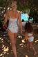 Girl's blue Starburst Crop Bikini Set with frill trims, walking towards a swimming pool on vacation.