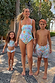 Girl wearing the blue Starburst crop bikini set with a smocked top and frill trim for a family vacation.