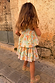 Back view of a girl wearing the blue cotton Starburst Skirt Co-ord Set with a peplum top and tiered skirt.