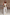 Thumbnail for Model wearing a gold metallic tank top and wide-leg Ecru Jan Jeans against a rustic stone wall.