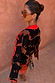 Tan Jaden Floral Jacquard cardigan with black floral patterns and red trim worn by a model.