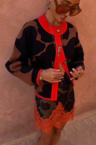Tan Jaden Floral Jacquard Cardigan with red trim and matching skirt featuring an orange lace hem.