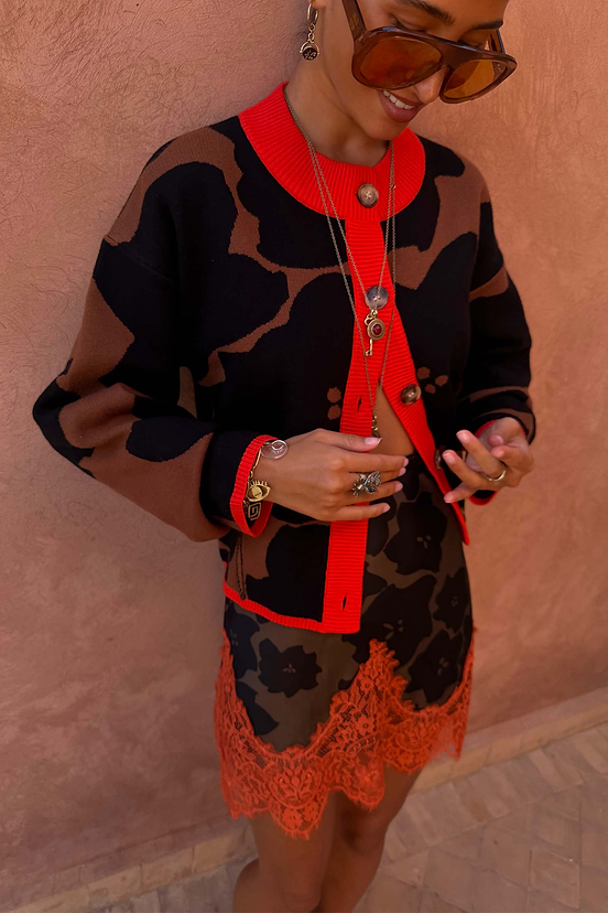 Tan Jaden Floral Jacquard Cardigan with red trim and matching skirt featuring an orange lace hem.
