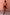 Thumbnail for Maeva Mini Skirt in Tan Jaden Floral Print with orange lace trim, styled with an orange tank top.