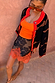 Maeva Mini Skirt in Tan Jaden Floral Print with an orange lace hem, styled with a matching cardigan.