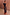 Thumbnail for Model wearing the Maeva Skirt in Tan Jaden Floral Print with orange lace trim and a black top.